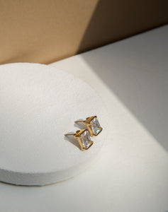 Introducing our exquisite PVD Gold Plated Stud Earrings. Crafted with precision, each stud showcases a contemporary square shape. The high quality AAA cubic zircon effortlessly capture and reflect light, illuminating your evenings with a brilliant glow. Unveil a touch of luxury with these high-quality, shimmering studs that redefine sophistication