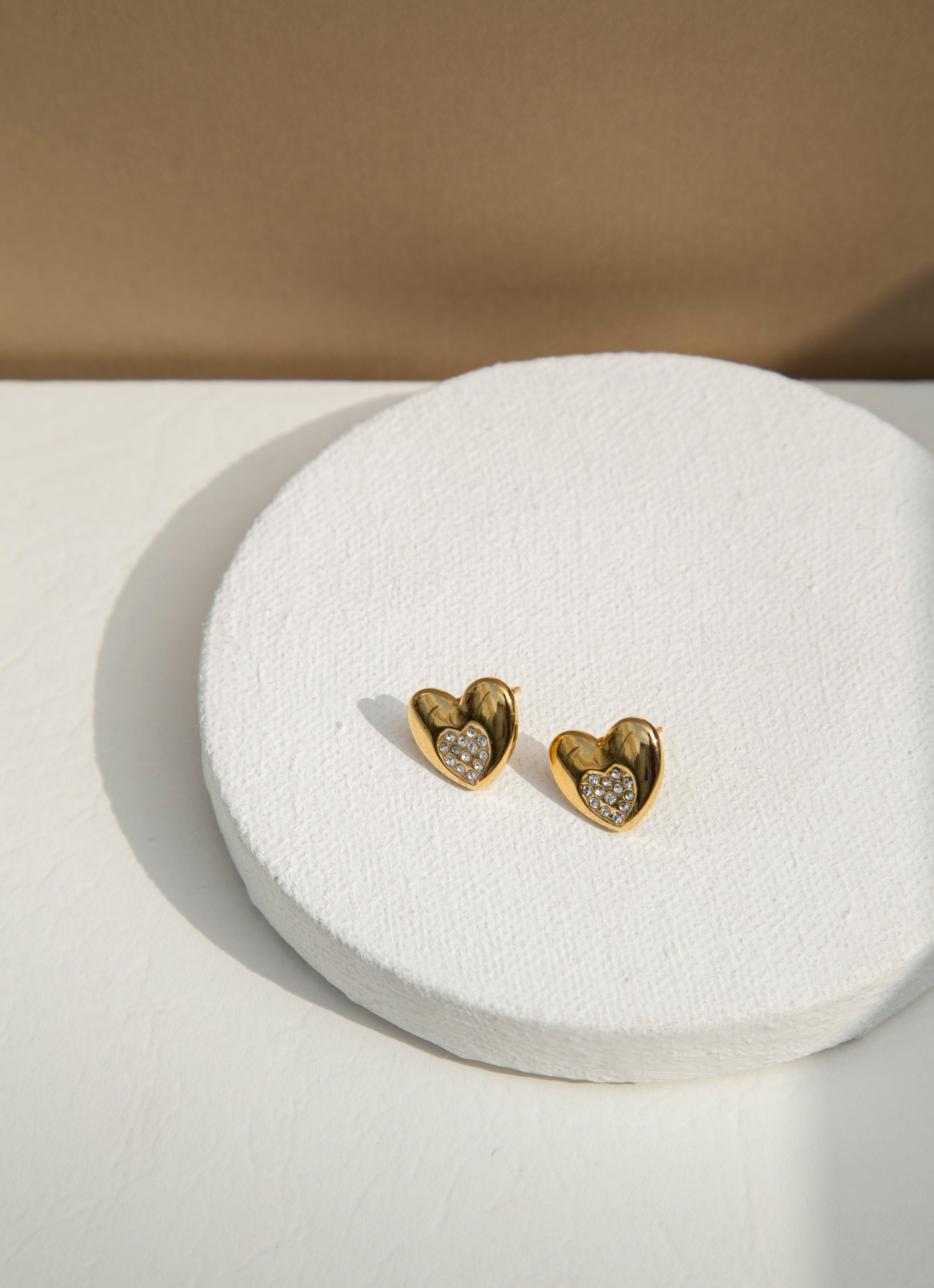 Material : Stainless Steel, Cubic Zircon  -18k Gold Plated   - Hypoallergenic   - Tarnish & Water Resistant   Dimension : Length 1.20cm   Weight : About 3g    Your search for cutest studs is over. Introducing Gigil Studs. Heart shaped stainless steel stud earrings, delicately plated in 18k gold and embedded with sparkling cubic zirconia that sparkle with every movement. These studs are definitely a must have and will get you lots of compliments.