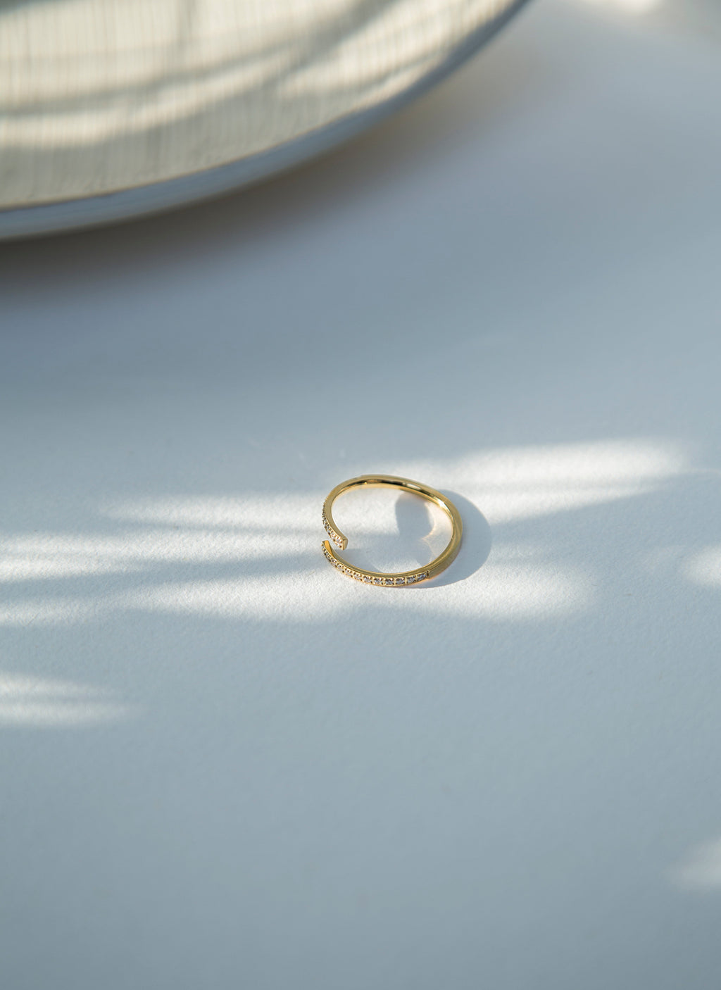 Sleek and subtle 'Lune Ring'. This adjustable minimalistic gold-plated ring is embedded with cubic zirconia. Crafted from premium materials, it promises both durability and a captivating shine that lasts. The adjustable feature ensures a perfect fit for any finger. A must have for all dainty jewelry lovers.