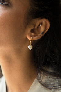 Embrace a soft, summery look with our Eva Earrings. Featuring a dangling charm crafted from natural mother-of-pearl white stone, these earrings are both cute and delicate. Each charm is made of natural stone, so every charm is unique and may vary slightly in color. Style these with your summer outfits and look super cute.