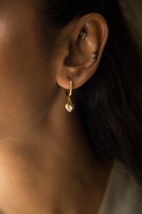 These earrings feature a dangling charm available in two options: a sparkling heart or a star. Crafted to be lightweight and adorned with a radiant gold-plated finish, they are the perfect blend of fun and elegance for everyday wear.