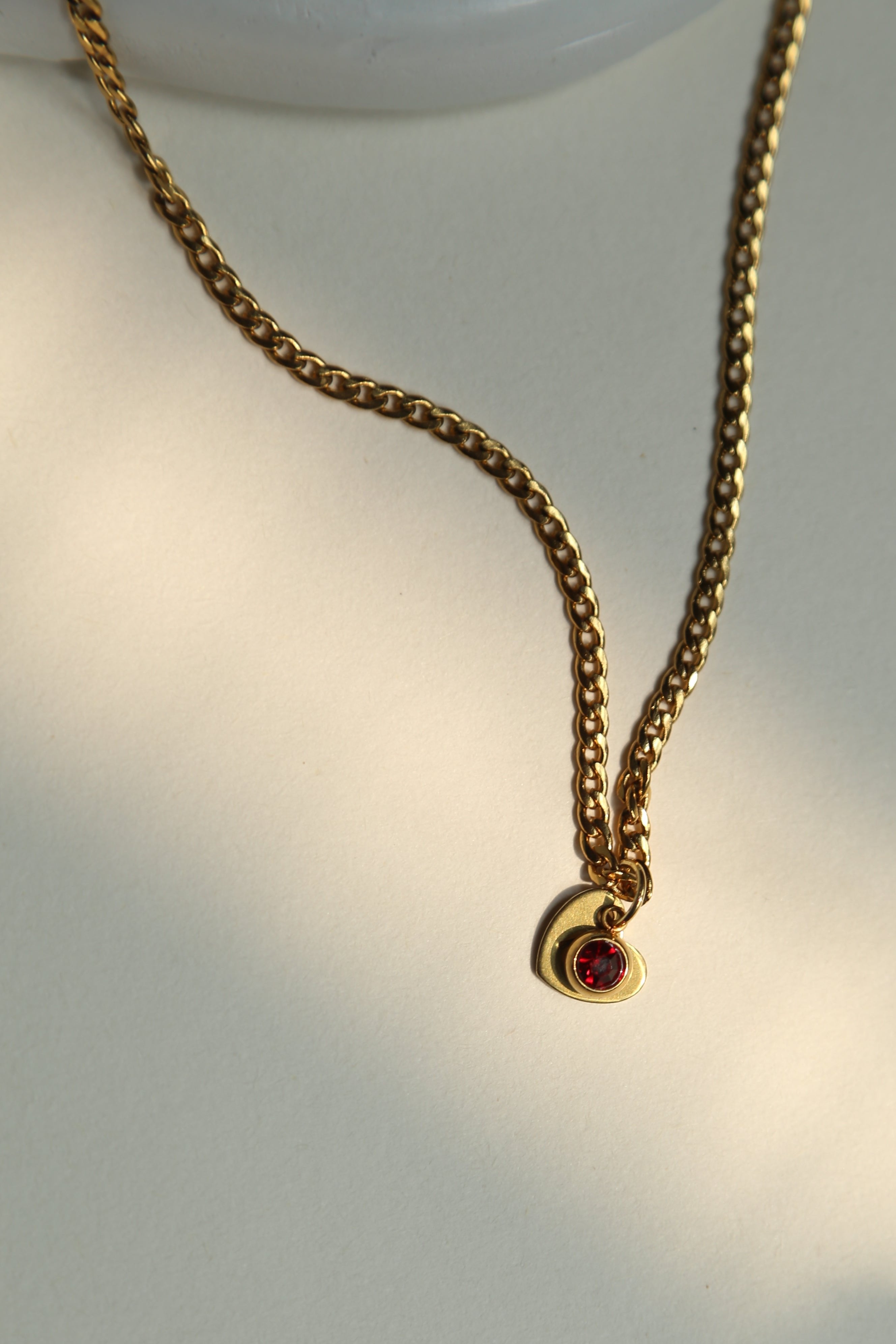 Length : 45CM

Material : Stainless Steel, Gold Plated&nbsp;

Discover the elegance of personalized jewelry with our Hidden Initial Necklace. This beautiful necklace features a heart-shaped disc pendant with a hand-stamped initial, subtly hidden behind a sparkling charm. Eye catching gold plated curb chain adds so much beauty to this necklace. The charm comes in four gorgeous colors to match your unique style.&nbsp;Hand made with love it can be a thoughtful and unique gift for your loved ones and you.