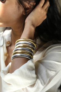 - Stainless Steel, 18K Gold Plated&nbsp;

- Hypoallergenic &amp; Tarnish Resistant

Introducing our Kalea Bangle bangle. The unique snake chain texture adds a touch of sophistication, making this bracelet a standout accessory for any occasion.

Available in both silver and gold, you can choose to wear a single bangle for a minimalist look or mix and match both colors to create a striking combination. Whether you opt for one or stack multiple bangles together, this versatile piece offers endless styling poss