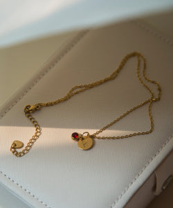 Discover the elegance of personalized jewelry with our Initial Necklace. This beautiful necklace features a round disc pendant with a hand-stamped initial of your choice, subtly hidden behind a sparkling charm. Delicate gold plated link chain adds so much beauty to this necklace. The charm comes in four gorgeous colors to match your unique style. It can be a thoughtful and unique gift for your loved ones and you.